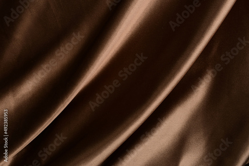 Silk textile brown or chocolate color, Luxury brown color creased smooth satin silk cloth texture