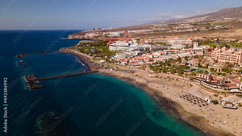 Fototapeta premium El Duque beach in Tenerife, with its incredible turquoise water and golden sand, is a favourite for lovers of the sun and relaxation, and has all the amenities