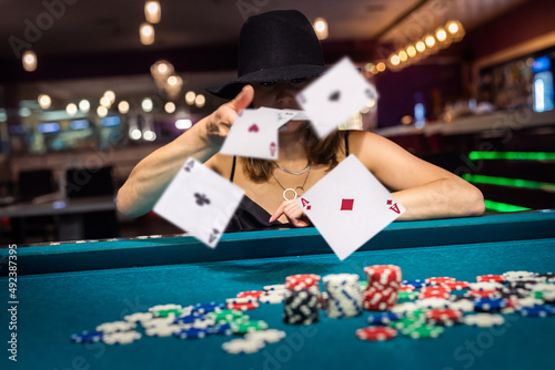 Photos Woman looking in play cards in casino