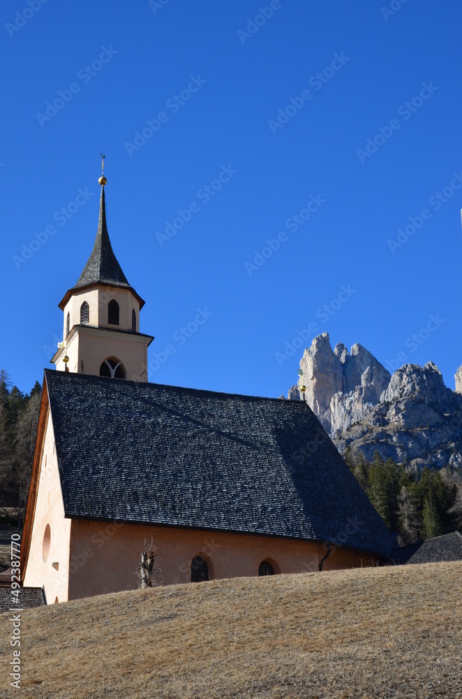 Photos of the snowcapped Dolomites during a winter trip and the small villages in the mountain valleys on a sunny, cold day