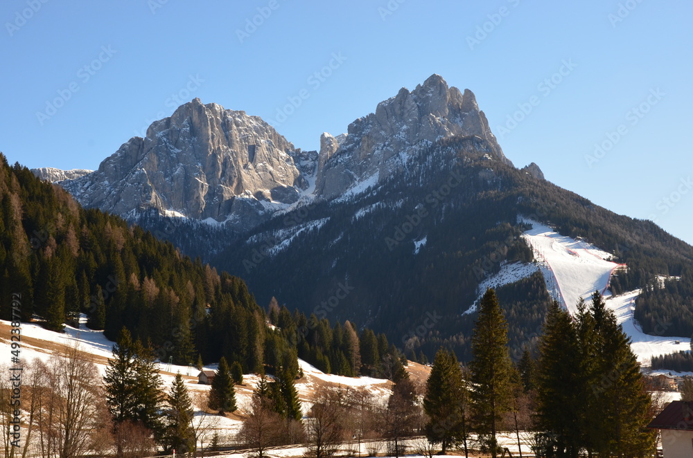 Photos of the snowcapped Dolomites during a winter trip and the small villages in the mountain valleys on a sunny, cold day