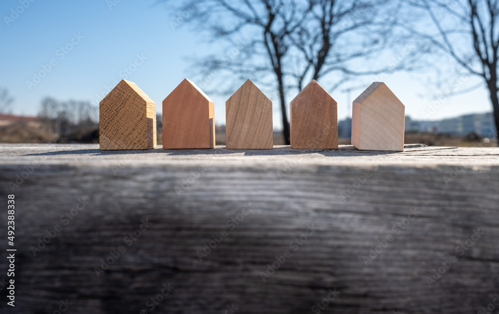 A Set Of Tiny Wooden Houses In A Row Concept Image For Wood As A