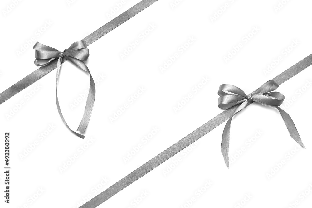 Beautiful silver bows with ribbons on white background Beautiful silver bows with ribbons on white background