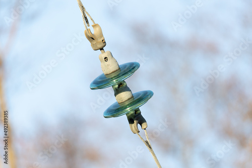close up of ceramic glass isolator and electrical wire cable
