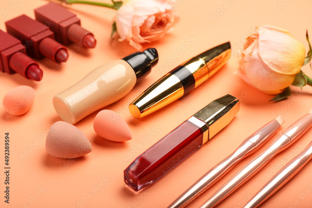 Obraz premium Set of decorative cosmetics with makeup sponges on color background, closeup