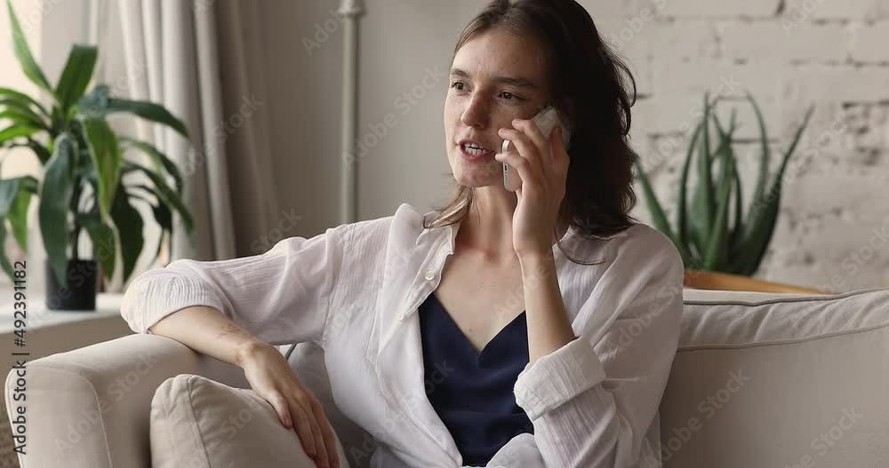 Young female teenager student chat on mobile phone hold device close to ear share news discuss affairs with friend. Energetic millennial woman relax at home make telephone call talk enjoy conversation Young female teenager student chat on mobile phone hold device close to ear share news discuss affairs with friend. Energetic millennial woman relax at home make telephone call talk enjoy conversation
