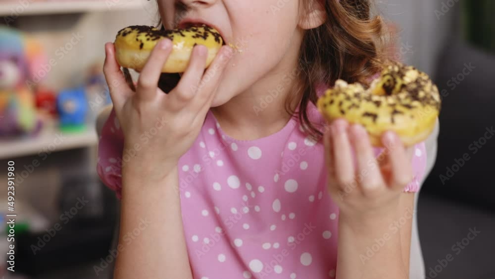 Portrait of young hungry girl eating donut. Female mouth bites a loaf. Close-up woman eating donut , delicious, sweet, sweet tooth at home background. Portrait of young hungry girl eating donut. Female mouth bites a loaf. Close-up woman eating donut , delicious, sweet, sweet tooth at home background.