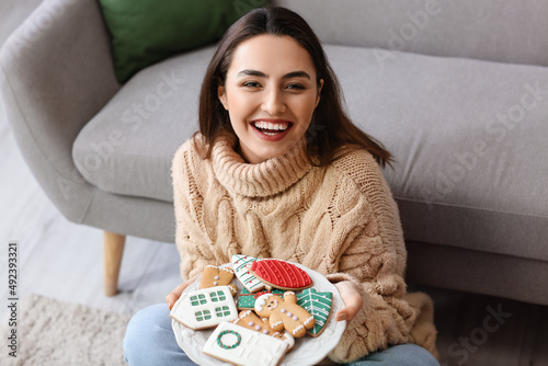Happy young woman holding p...