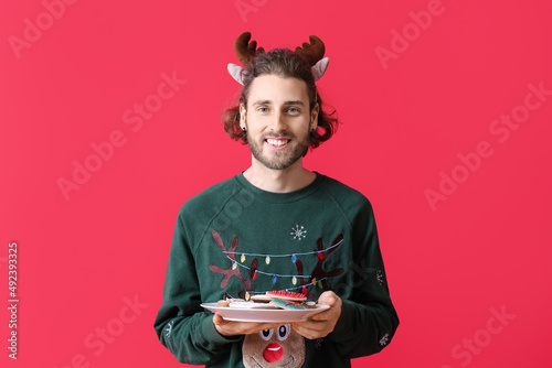Happy young man in deer hor...