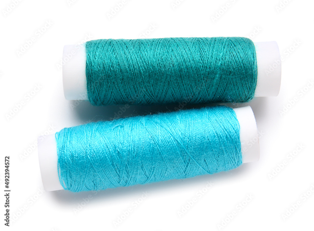 Different thread spools on white background Different thread spools on white background