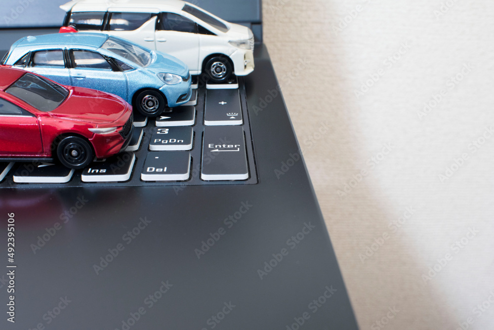 Naklejka premium laptop and 3 cars