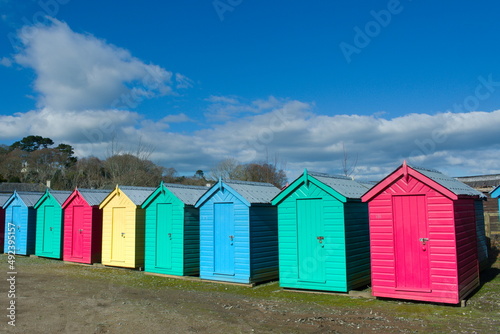 Iconic, traditional beach huts. Typical British seaside scene at Abersoch, north Wales on a sunny spring day. © John