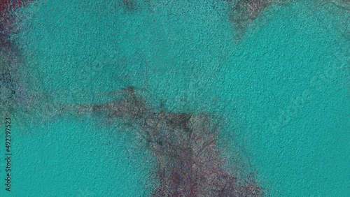 Blue painted wall and Aquamarine colored background with textures of different shades of aquamarine or turquoise.