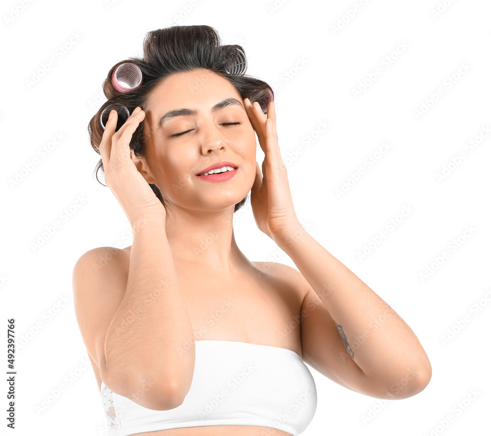Happy young woman in hair curlers on white background Happy young woman in hair curlers on white background