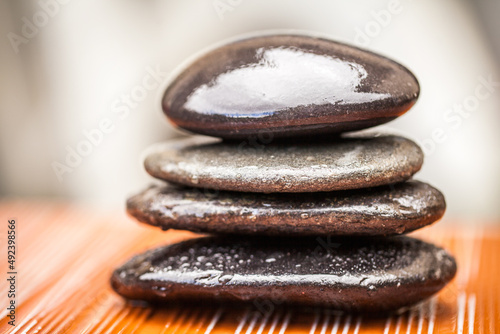 Find your balance. Closeup shot of wet lastones stacked on each other. photo