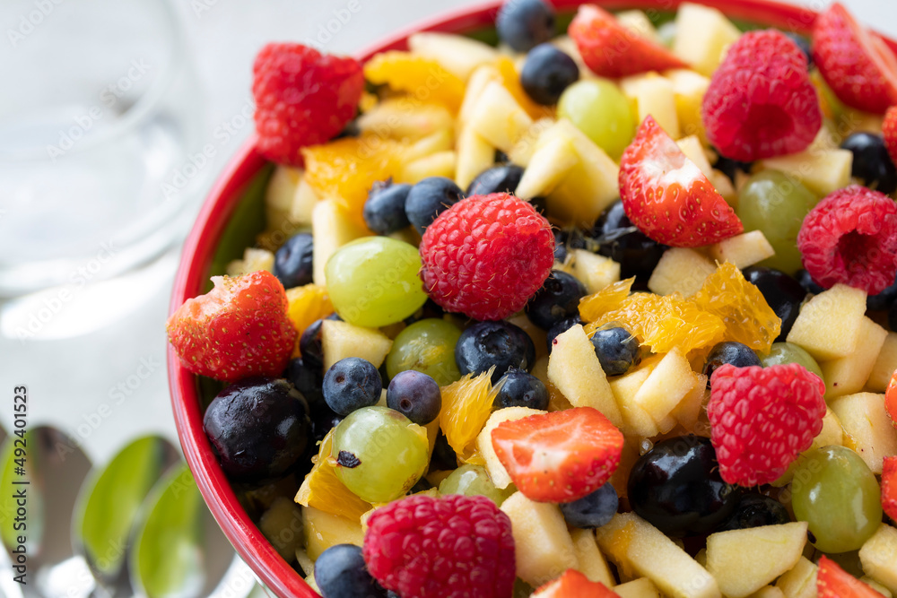 Colourful fruit salad in bowl close up