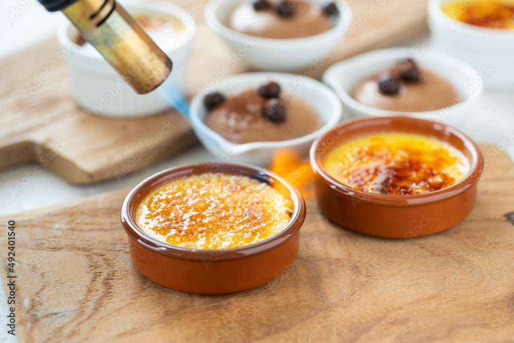 creme brûlée vanilla dessert sugar crust being caramelised with torch other dessert on background creme brûlée vanilla dessert sugar crust being caramelised with torch other dessert on background