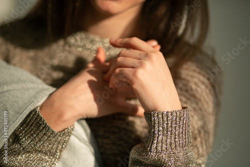 Hands of beautiful skinny brunette girl holding clothes on her hand
hands of a young girl in the foreground beautiful skin manicured hands
