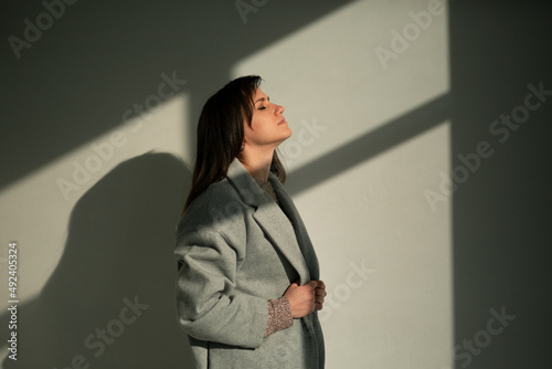 girl in a gray coat stands with his back
portrait young beautiful brunette standing sunlight long straight hair eyes brown long eyelashes girl smiling dreams
