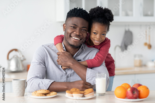 Family portrait of african american father and daughter having breakfast