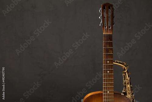 Acoustic guitar and saxophone on floor. Music concept in studio with musical instrument