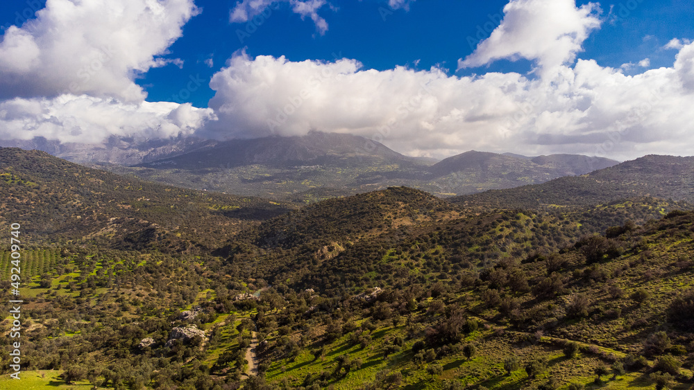 Beautiful and scenic aerial shot of a mountain landscape with  clouds in Crete, Greece