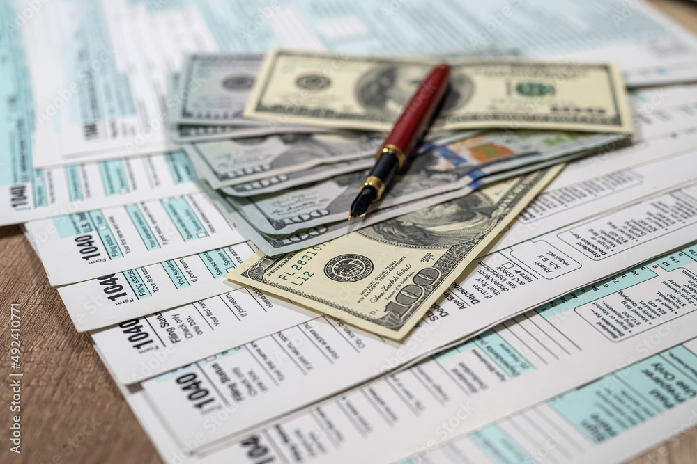1040 individual income tax return with dollar on table 1040 individual income tax return with dollar on table