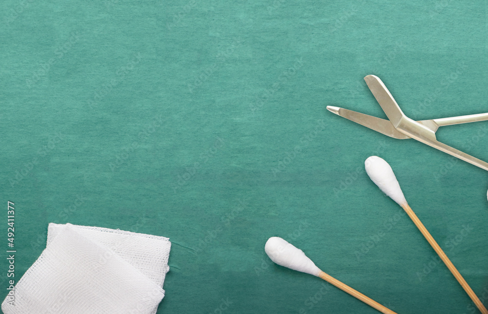 Gauze and swab cotton bus sticks on green medical surgical dress with copy space Gauze and swab cotton bus sticks on green medical surgical dress with copy space
