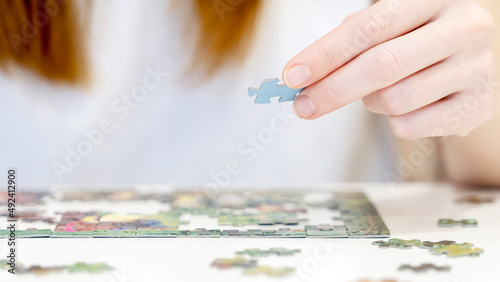 the girl collects puzzles in close-up