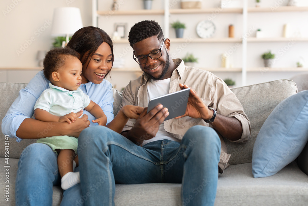 Portrait of black family using digital tablet at home Portrait of black family using digital tablet at home