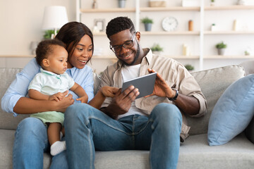 Portrait of black family using digital tablet at home
