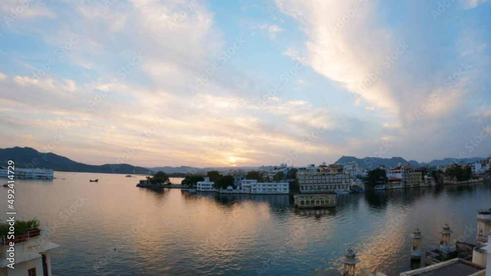 4k timelapse of Udaipur city during sunset with dramatic cloudy sky. Lake Pichola with palace and buildings on shore. Clouds moving in sky timelapse 4k timelapse of Udaipur city during sunset with dramatic cloudy sky. Lake Pichola with palace and buildings on shore. Clouds moving in sky timelapse