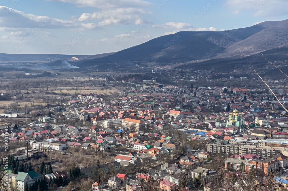Ukrainian town near mountains, landscape in the sunny day.