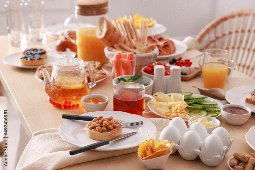 Dishes with different food on table indoors. Luxury brunch
