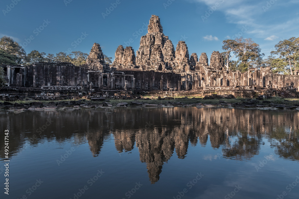 Ruins of ancient Khmer temple are reflected in pond still water, Angkor Complex, Siem Reap, Cambodia Ruins of ancient Khmer temple are reflected in pond still water, Angkor Complex, Siem Reap, Cambodia