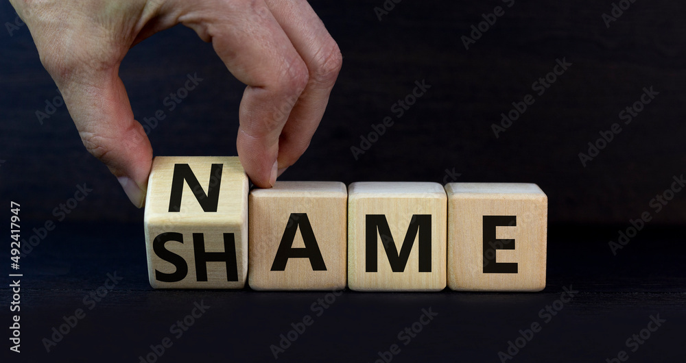 Name or shame symbol. Businessman turns the wooden cube and changes the