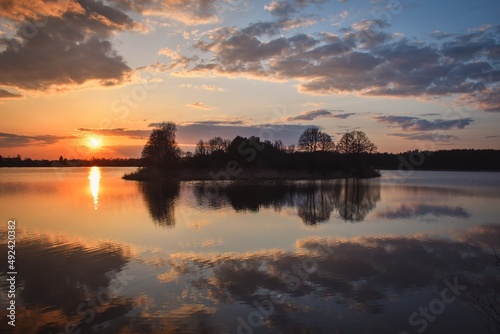 Beautiful morning spring landscape. Sunrise over the lake with a beautiful sky.