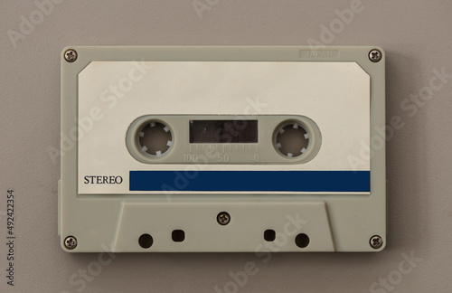 audio cassette tape isolated on beige background. Close up view.