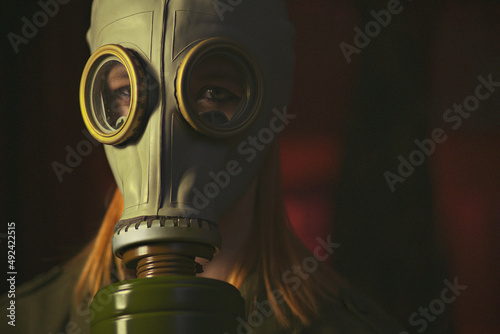military girl in a gas mask against radiation