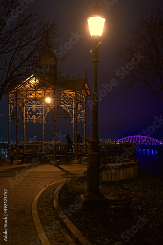 a lantern shines at night in the park of Kyiv