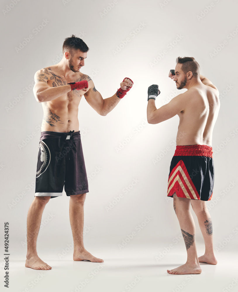 Who do you think will win. Full length shot of MMA two fighters ready to battle.
