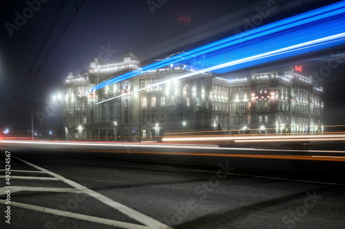 Long-exposure glimpses of passing vehicles on the main square of the city of Rostov.
