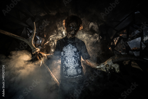 scary sorcerer in smoke. voodoo rite