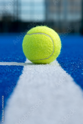 Bright blue tennis, paddle ball or pickleball court close up of service line outdoors. selective focus © Vic