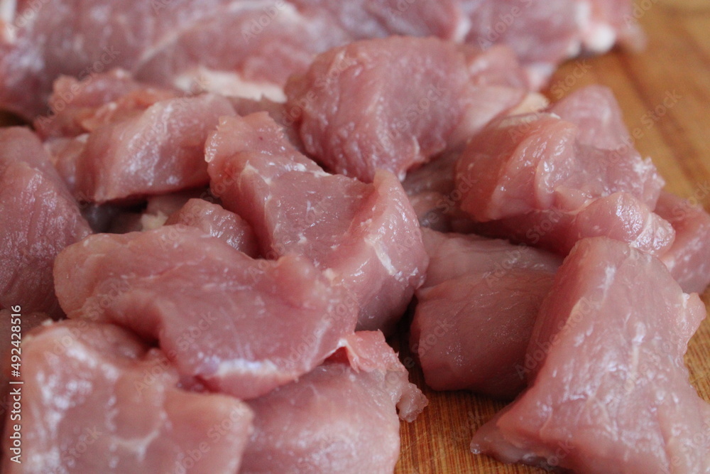 Pieces of fresh red meat on a wooden board Pieces of fresh red meat on a wooden board