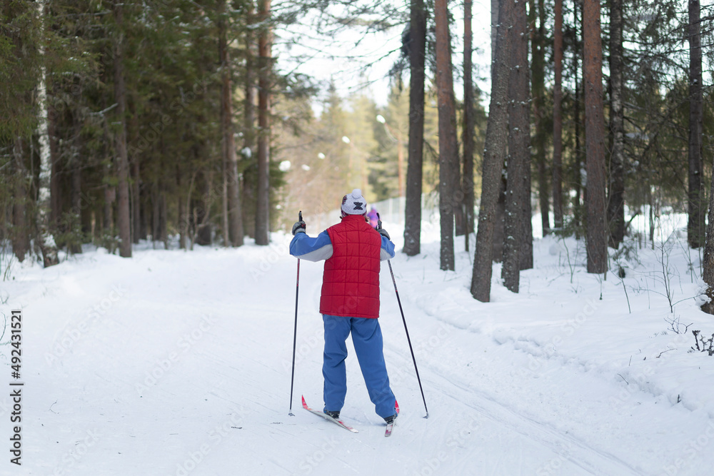 Cross country Skilling. A skier goes skiing on the ski track. Cross country Skilling. A skier goes skiing on the ski track.