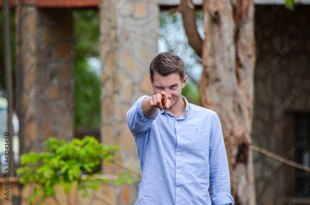Handsome man (tourist) pointing his finger at the camera, Tsavo East, Kenya, Africa Handsome man (tourist) pointing his finger at the camera, Tsavo East, Kenya, Africa