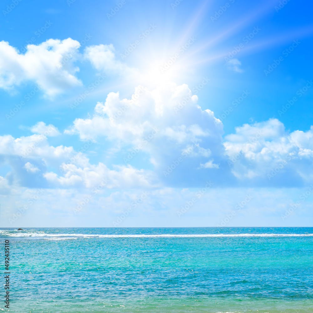 Tropical beach, azure ocean and sun on blue sky. Tropical beach, azure ocean and sun on blue sky.