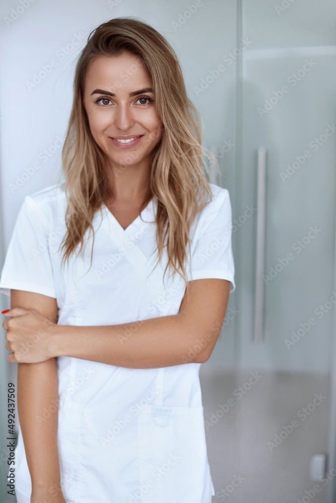 Smiling female doctor in hospital corridor. Patients consultation. Smiling female doctor in hospital corridor. Patients consultation.
