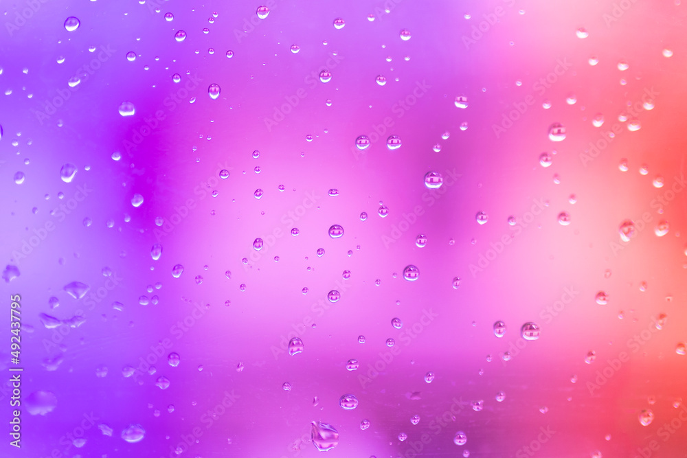 Rain drops on pink and purple gradient background